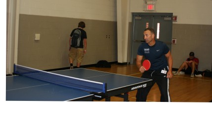 Coach John Turnbough plays ping pong in Gym 2.