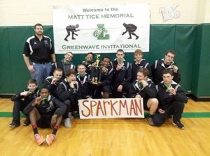 Wrestling team poses with trophy after making school history