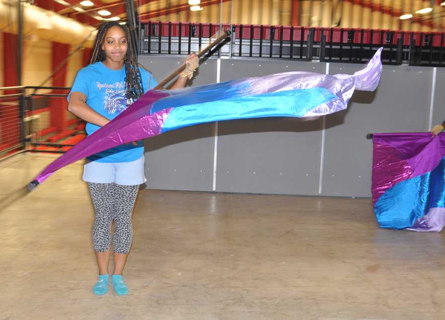 Junior DeAsia Johnson practices for the upcoming competitions. The winter guard uses the Ninth Grade cafeteria to prepare for their performances. 