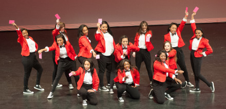 The dance team ends their dance at competition holding pink slips. The prop went with the song. 