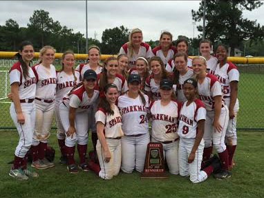 The softball team poses with thier runner-up trophy after the tournament.