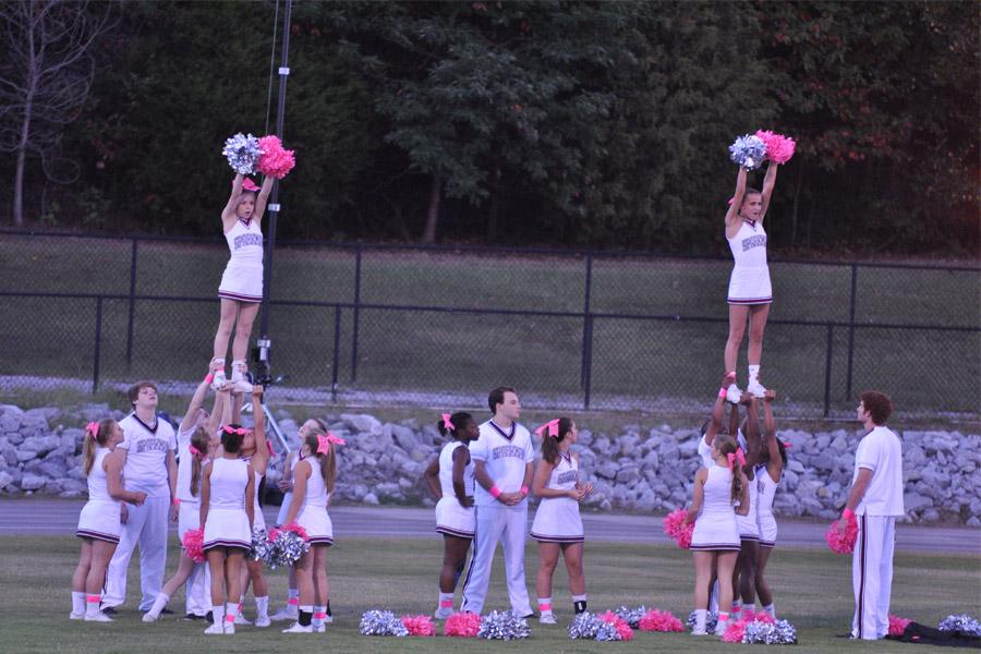 Cheerleaders+practice+out+on+the+football+field.