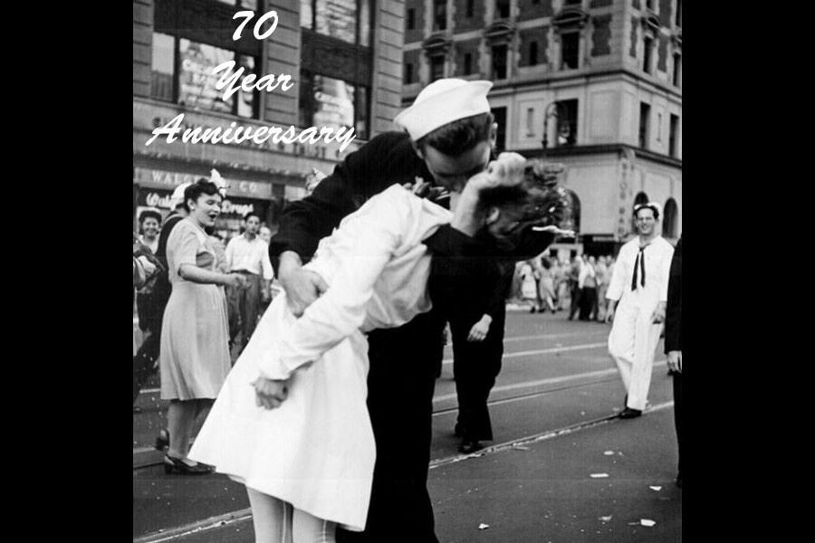 Shown above is the famous “coming home kiss” in New Yorks’ Time Square on V-E day. The famous scene is shown from a different angle, as captured by a Naval photographer. Showing  photo instead of the LIFE one is used here for copyright reasons.
Photo via Lt. Victor Jorgensen / The National Archives