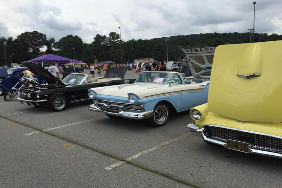 Cars await inspection at the car show.