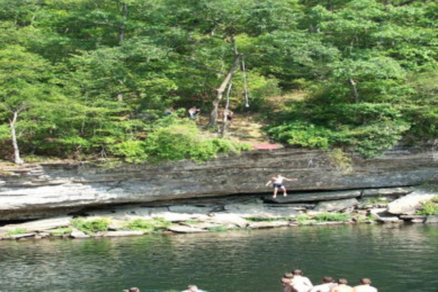 A view of visitors jumping at the Hippie Hole