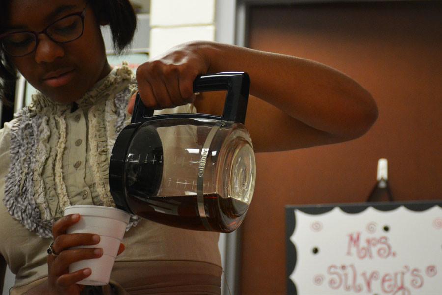 DAhara Hinton pours herself some tea during her AP English 12 class.