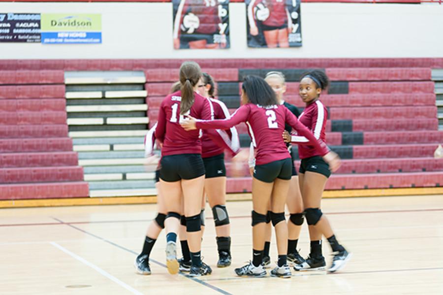 The volleyball team supports each other at the beginning of the season. The teams season ended in October. 