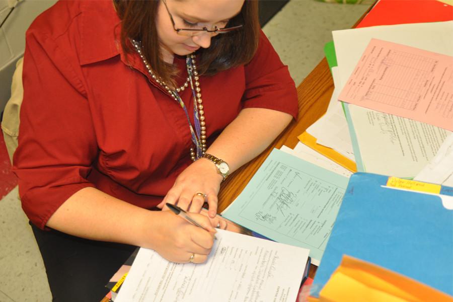 English teacher Mrs. Quaife works dilligently at her desk.