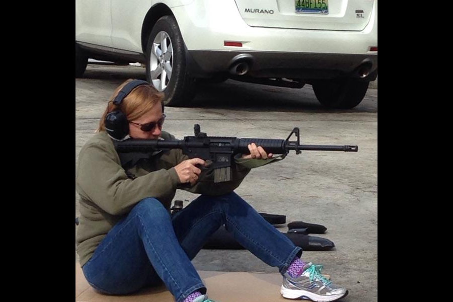 Teacher Paula Munts continues her time with the Marines by firing an AR-15.