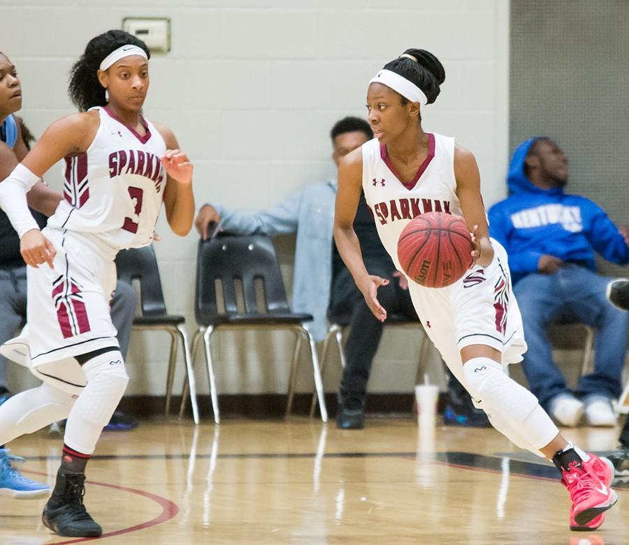 Terri Smith drives the ball up the court in a game against Lee High School. 