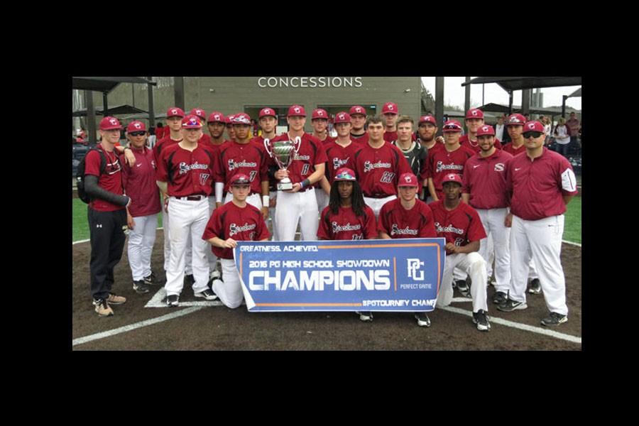 The baseball team takes a break after the tournament to pose for a victory picture.