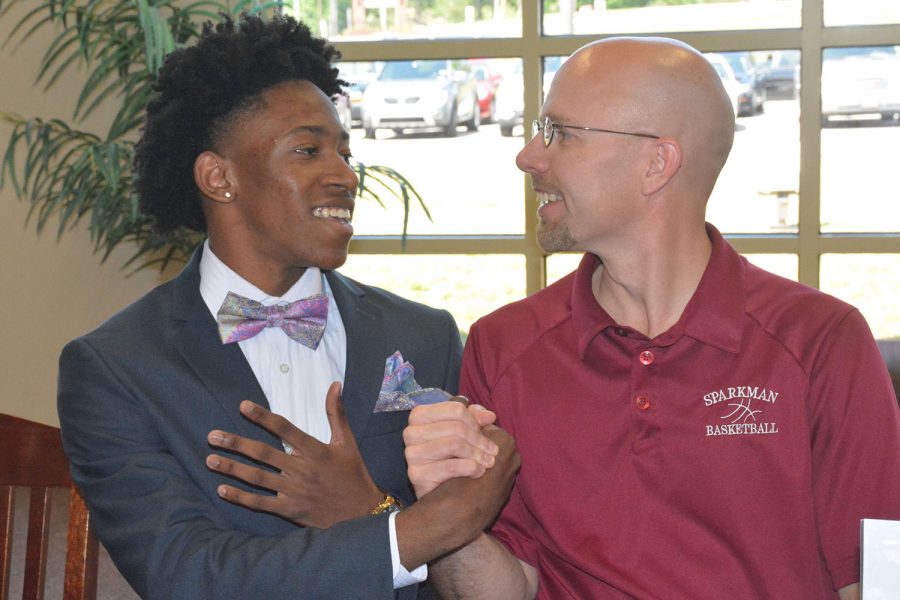 Senior Brandon Miller teaches coach Jamie Coggins how to dab. Miller will play basketball at Edward Waters College in the fall. 