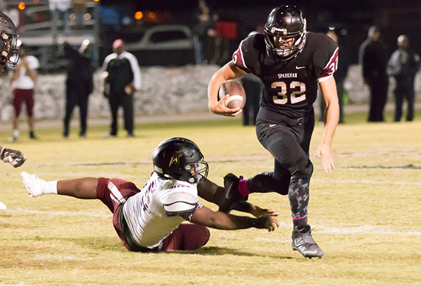 Eluding a Gadsden City tackle, senior Hunter Gibson runs for the endzone. 