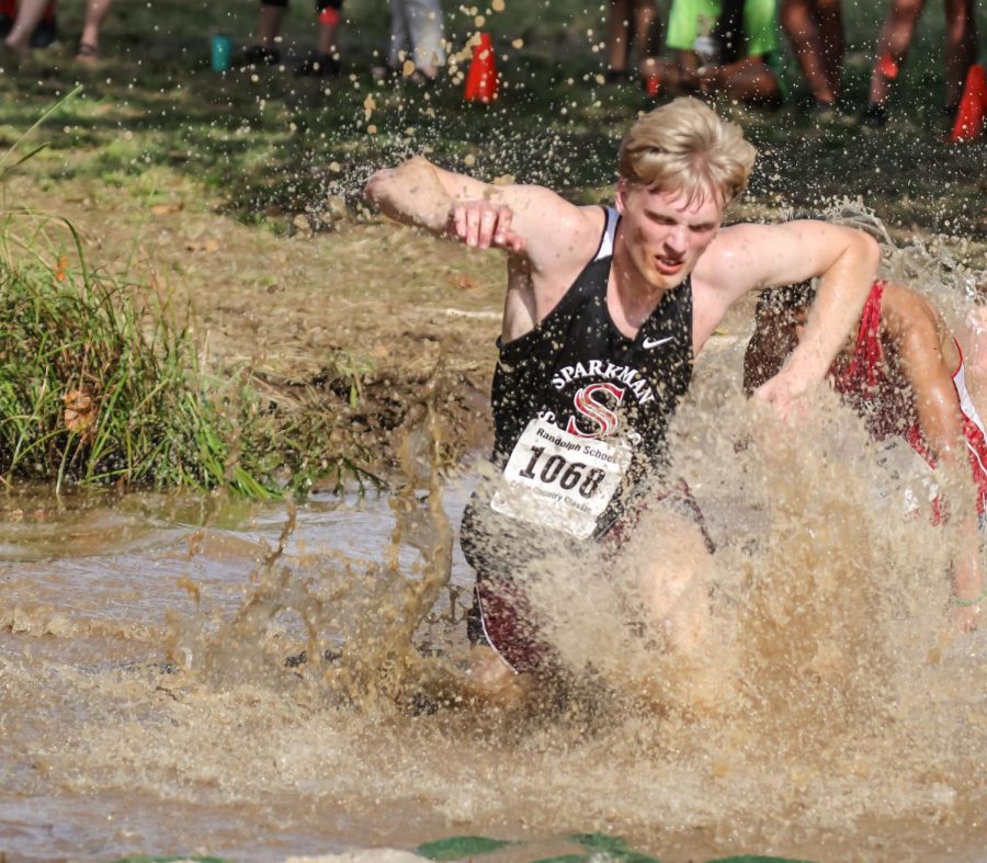 Senior John David Ray runs through a mud hole in the annual UAH Mud Run. 