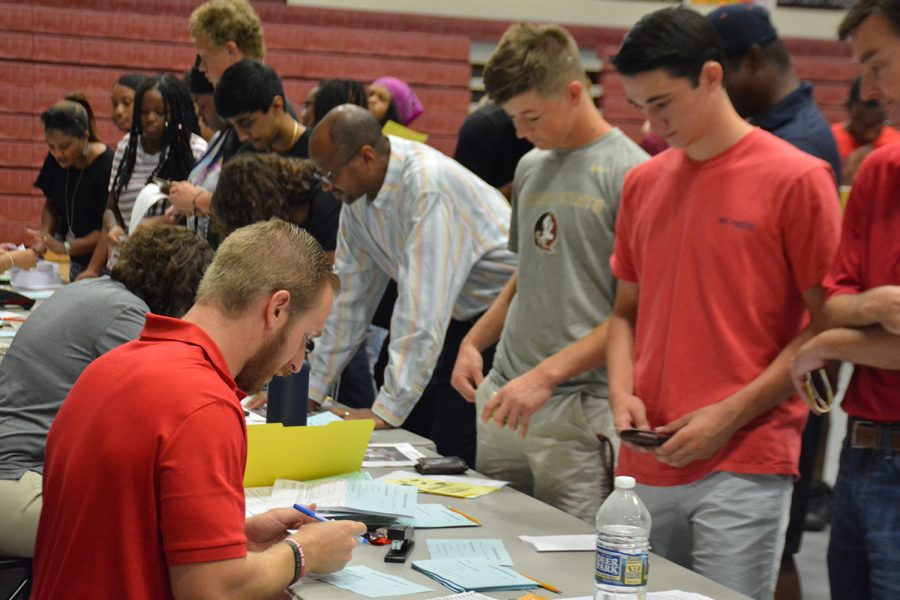 Seniors start their final year by picking up their schedules on Senator Day. 