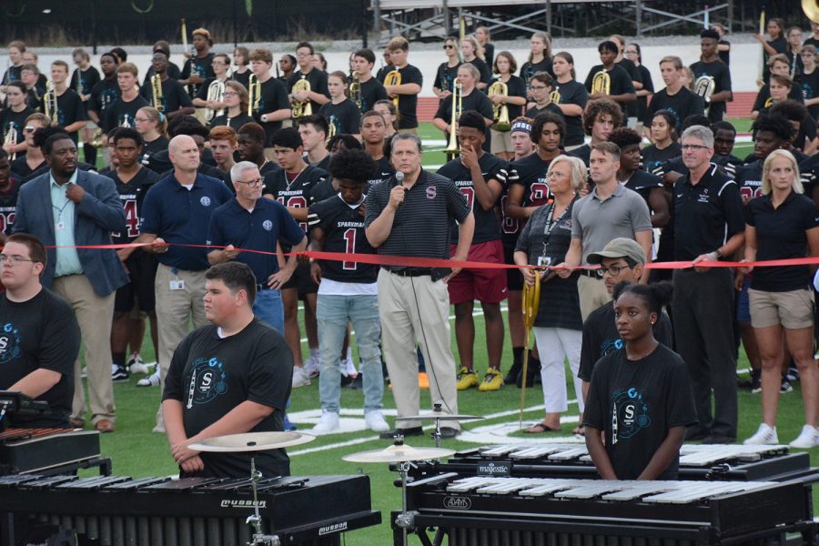 The school held a ribbon cutting ceremony for the new athletic facilities on Friday, Aug. 9. Principal Chris Shaw spoke with the crowd before cutting the ribbon. 