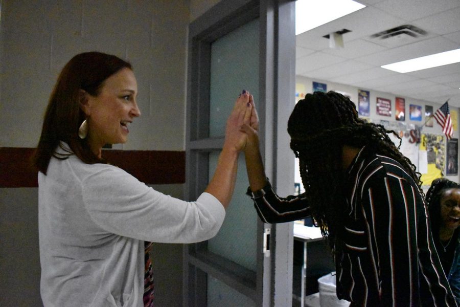 Mrs.+Deborah+Keller-Mitchell+gives+a+high-five+to+one+of+her+scholars.+