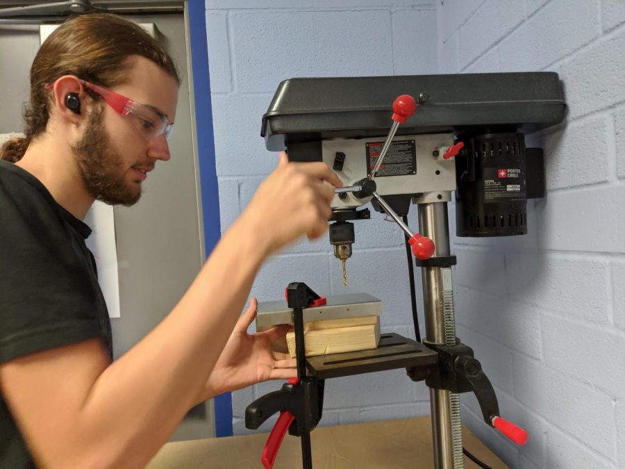 Using a power saw, senior Luke Dynes works on a portion of the payload project. The team cannot release any information on their payload until a winner has been chosen. 