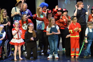 Performing their latest play, students work with the kids at Merrimack Hall. 
