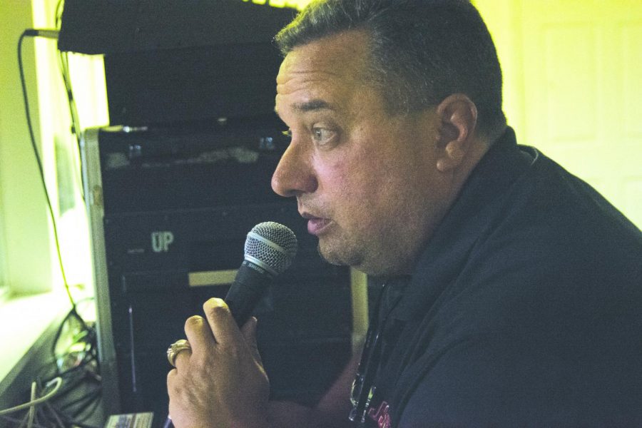 Calling out the sponsors, announcer David Owens fills up a time out. Owens calls every home football game. 