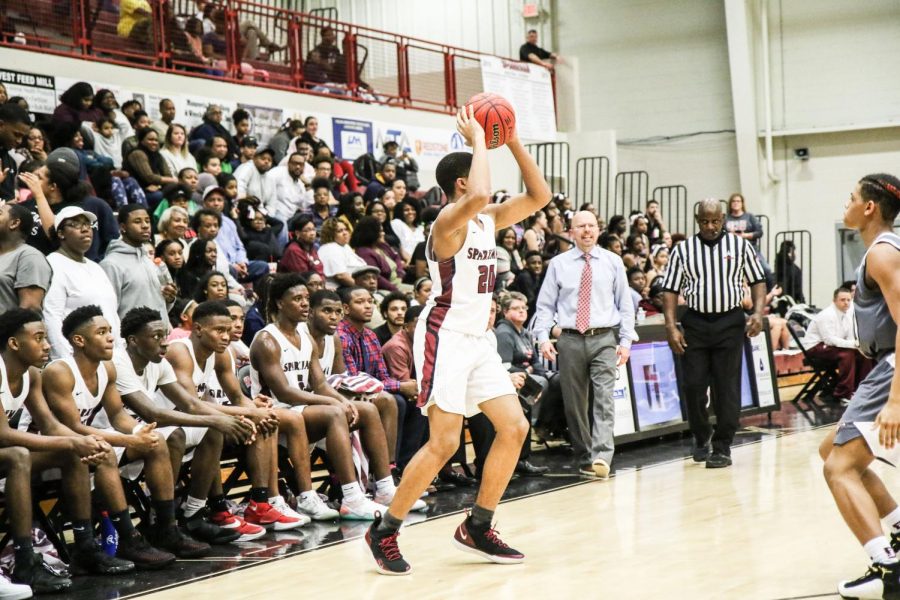 Sophomore Tyrese Elliott looks for an open player to make a pass. Elliott had five points in the first game of the season. 