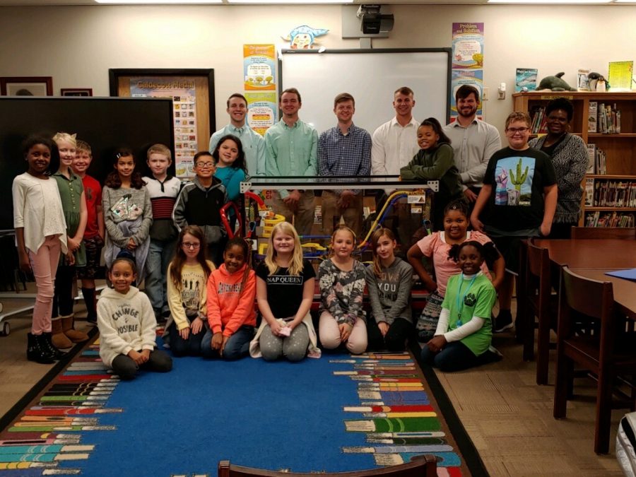 Students pose with UAH students after completing a project. 