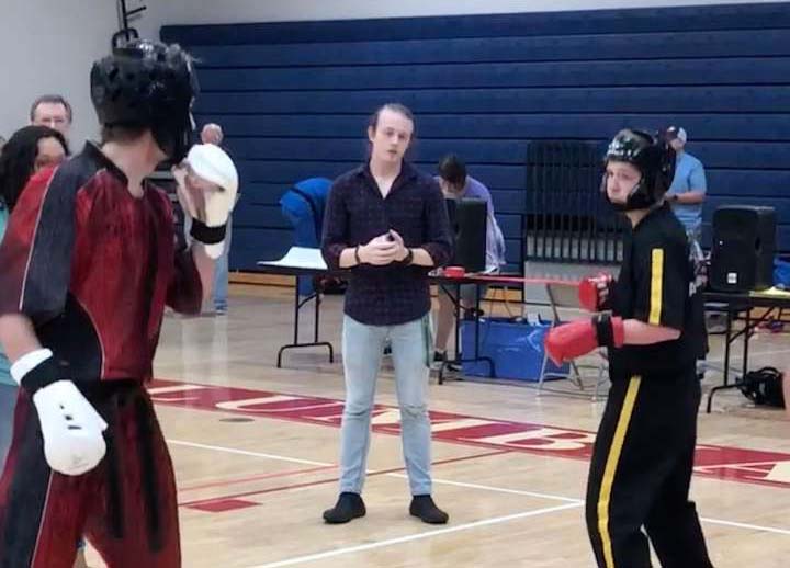 Getting into position, junior Austin Jennings waits for his instructor to give a command. Jennings teaches karate as well as takes courses. 