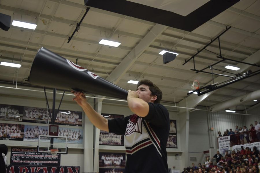 Junior Hayden Ottum chants cheers into the megaphone, bringing the team to victory at Regionals. 