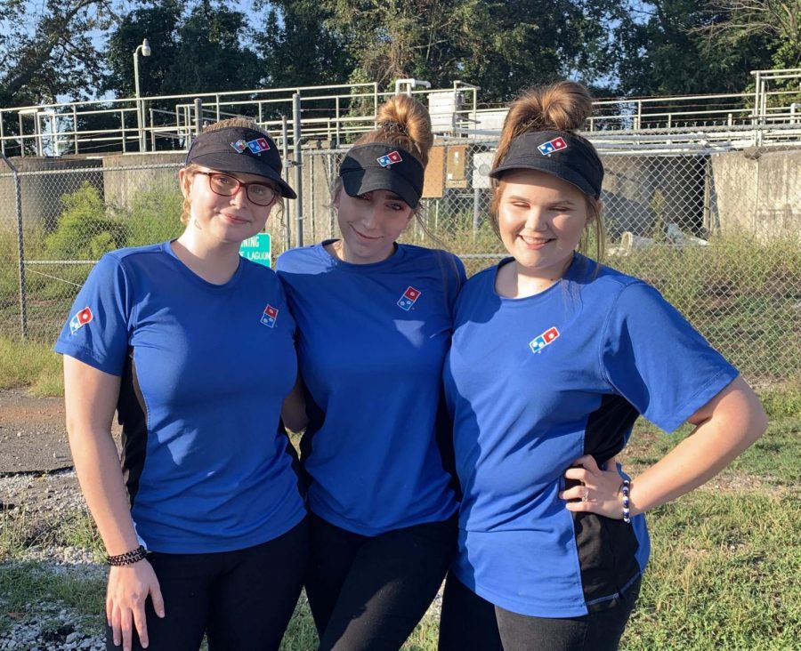 Taking a break from work, junior Grace Moore gets a quick photo with her friends. Juniors Madi Duboise and Katlyn Dickey worked together at the same Dominos on Hwy. 72. 
