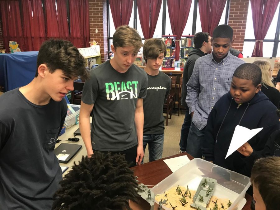 Great Wars students Ethan Cuzzort, AJ Troupe, Garrett Gonterman and Victor Dunagan discuss D-Day with a Harvest Elementary student. The boys built their own version of Utah Beach to share with the students. 