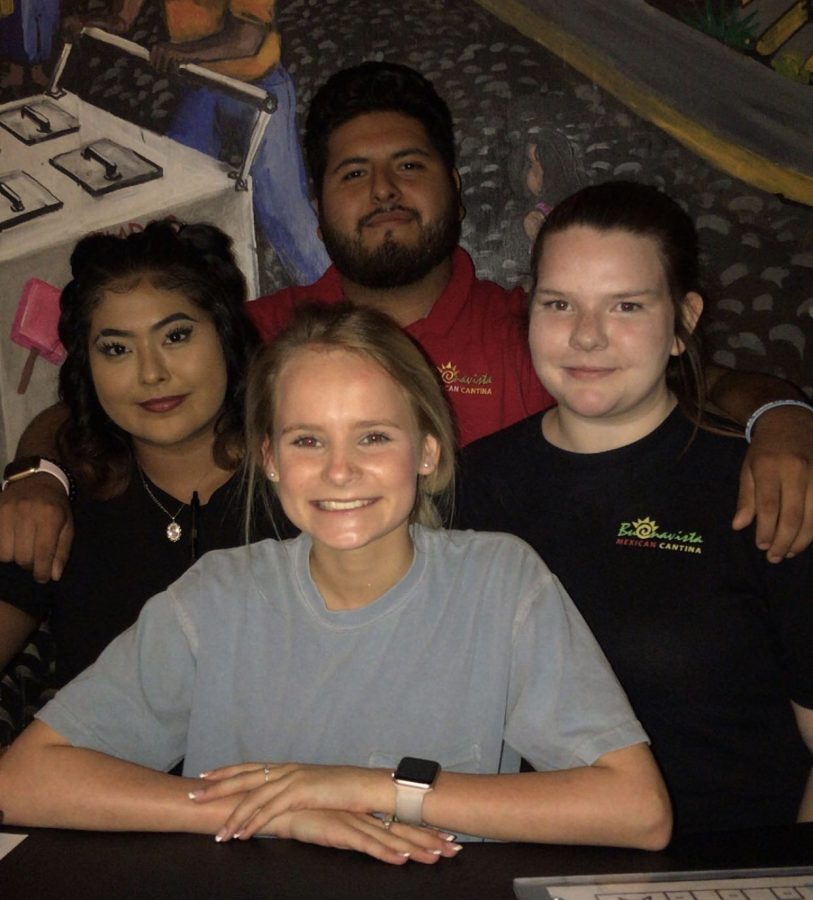 Opinion Editor Anna Herren poses with her co-workers at Buenoavista Hampton Cove.