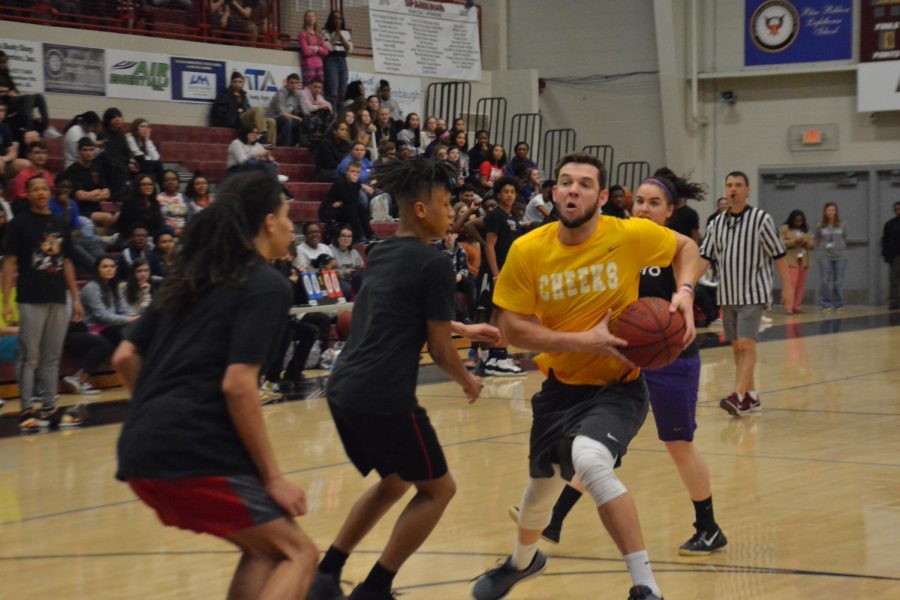 Taking the ball to the hoop, coach Nathan Nelson tries to draw a foul. 