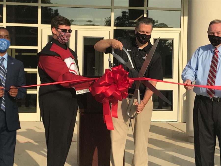 Principal Chris Shaw cuts the ribbon at Fridays ceremony opening the new Fine Arts Facility. 