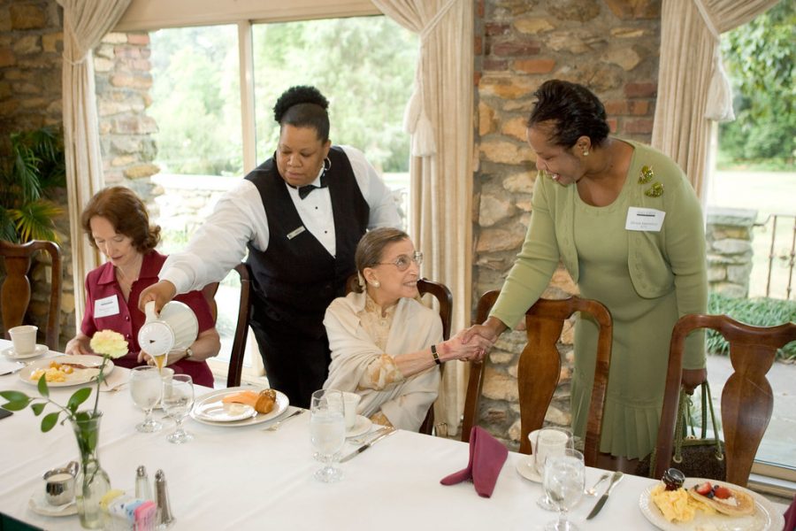 Justice Ruth Bader Ginsburg greets people at an event. Ginsburgs death led to the debate over whether or not President Trump should be able to nominate a replacement.