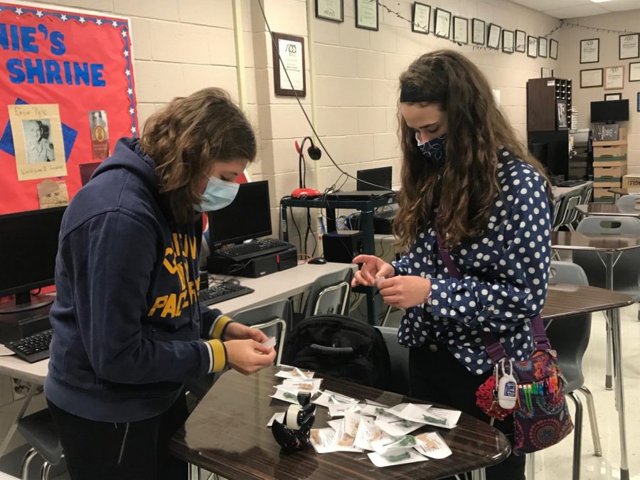 Putting together Veterans Day gifts for teachers, Ellie Ottum and Elsie Bradshaw stuff bags with toy soldiers. The Teens for Troops club has met two times to plan the years activities. 