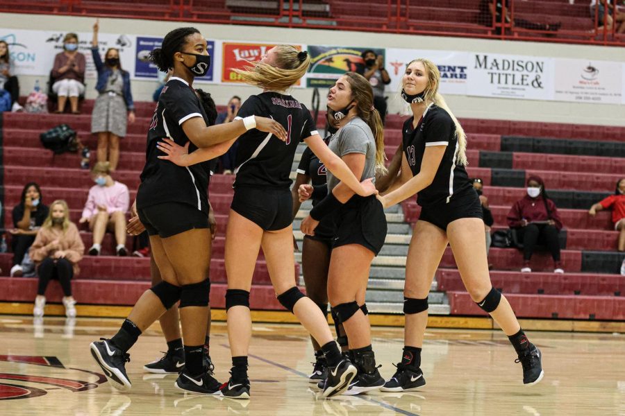 Member of the volleyball team celebrate after a big play in the area championship. 