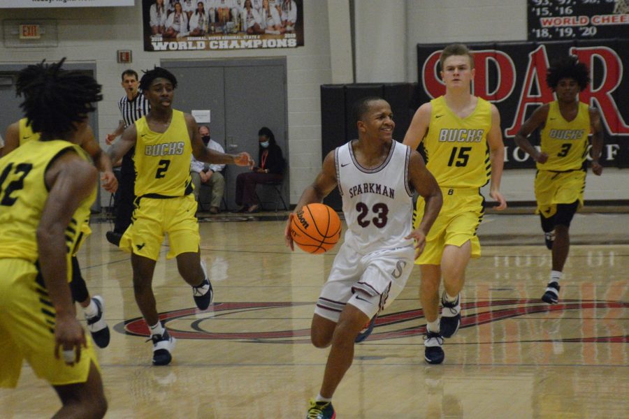 Senior Xavier Williams looks for a team member to pass the ball to. Williams scored 13 points in the first half. 