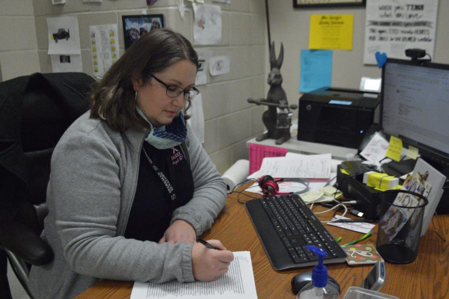 Using a rubric, creative writing teacher Renee Quaife grades the TED Talks while students present. 