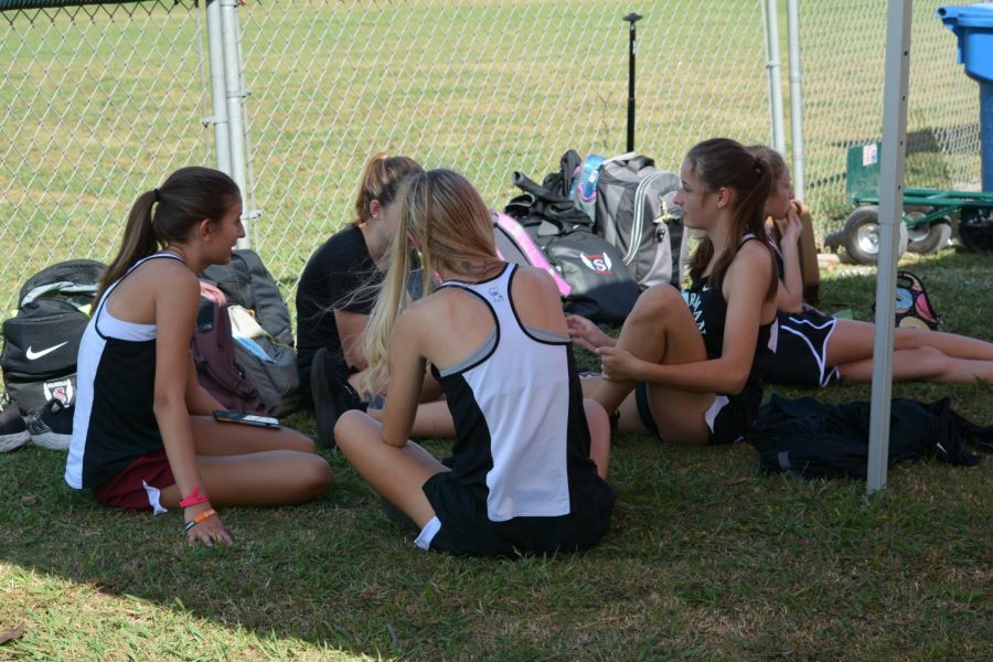 The girls cross country team take a break at the James Clemens Invitational. The team was supposed to be honored at their annual banquet in November. 