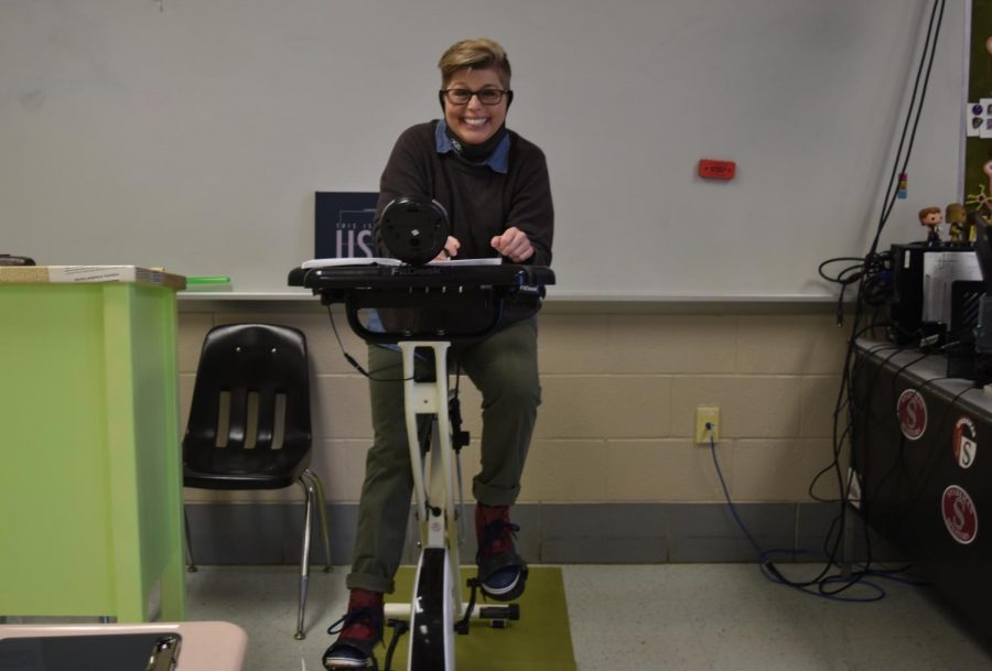 English teacher Monica Davis demonstrates how she teaches and grades from her bike. 