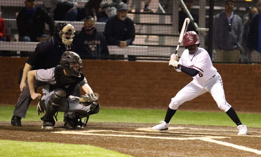 Setting up his stance, junior Chris Sims looks for the pitch. 