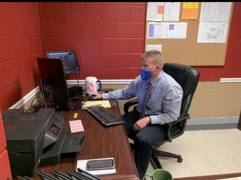 Mr. Rogers sits in his office catching up on his first week of work. Rogers was hired to replace Mrs. McCants after she took the position as principal at S9. 