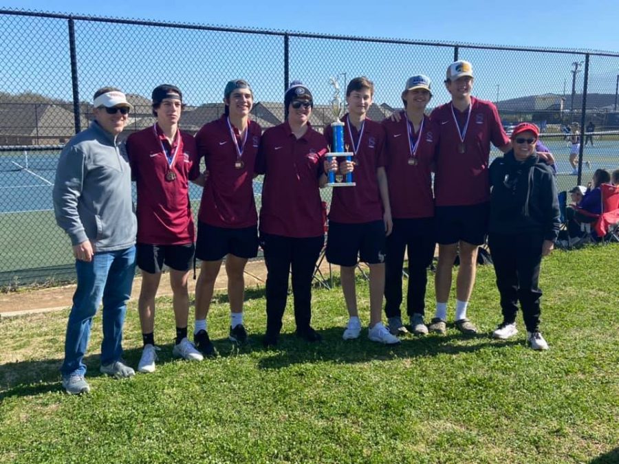 The boys tennis team poses with the trophy they won for being Madison County Champs. 