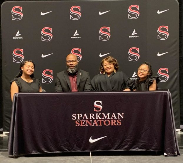 Coach Jarvis Wilson poses for a photo with his wife and daughters at the press conference announcing his hiring. Wilson has already begun working with the team. 