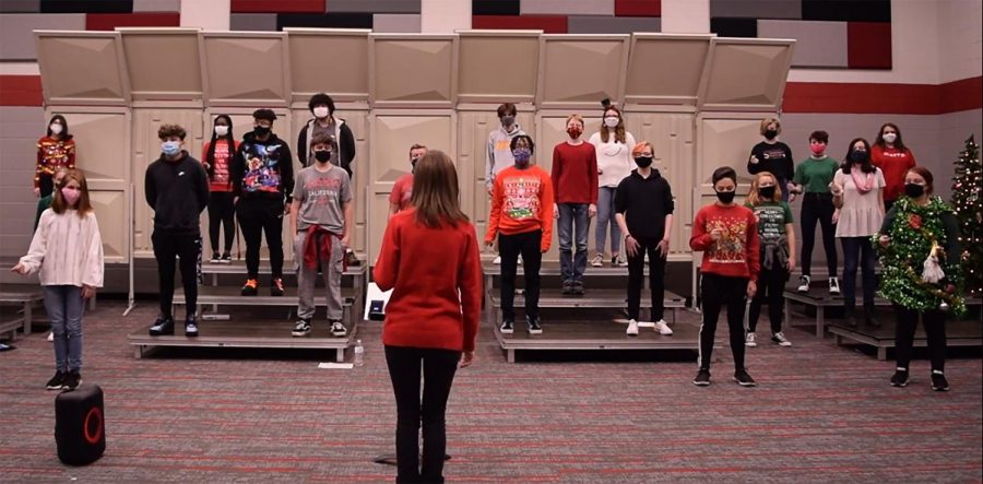 Choir teacher Caitlin Torrence leads the choir in a practice for their first concert  in December. The choir held a virtual concert then. 