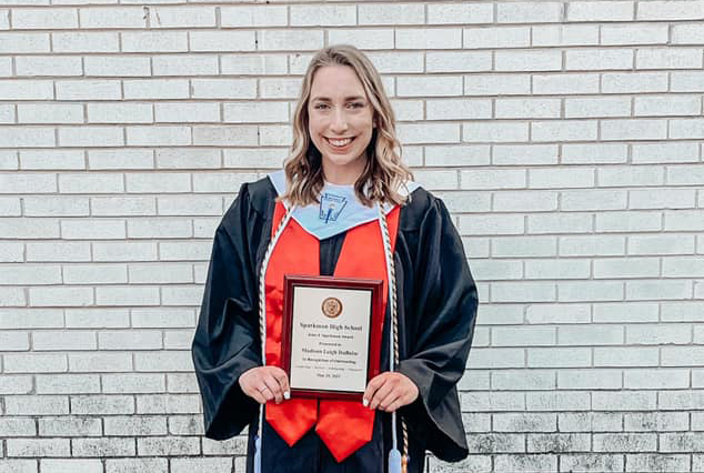 Senior Madison Duboise shows off her John J. Sparkman Award after the May 25 graduation ceremony. 