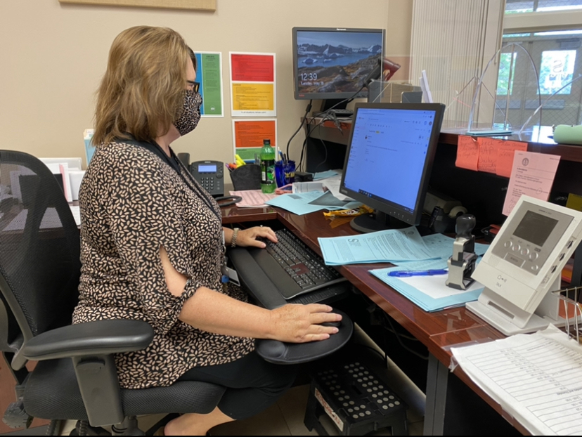 Attendance clerk Cathy Robinson catches up on check-ins for the day. Robinson turned in her retirement papers in January after 24 years in the school system. 