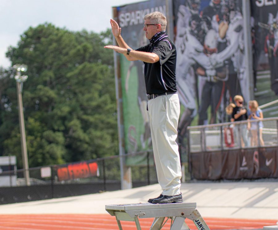 Band director, David Raney, directs the band during practice. 