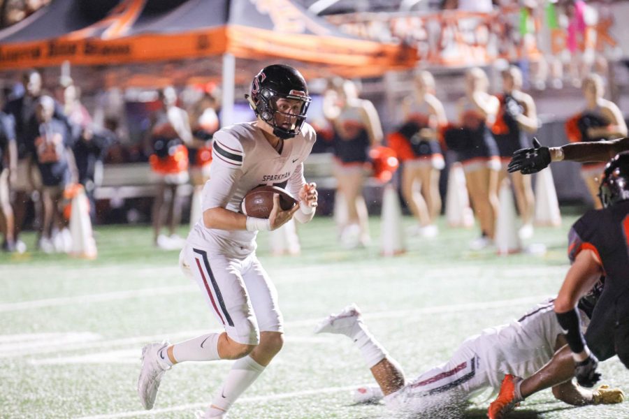 Senior Luke Schomburg runs the ball to salvage some yards in the game against Austin. 