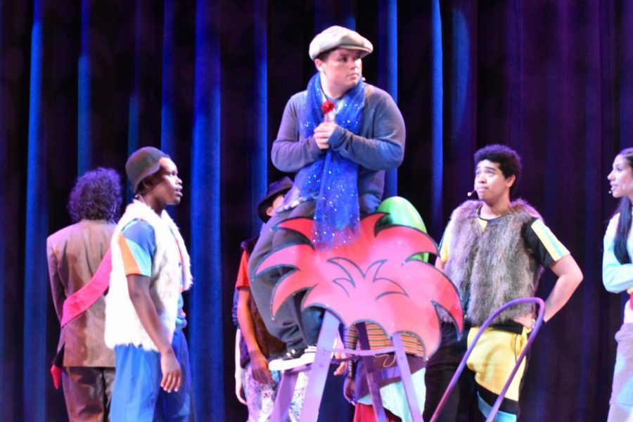 Portraying Horton the Elephant, senior JJ Lee sits on the fern prop. The students will present Seussical at the annual Trumbauer competition on Friday, Nov. 5